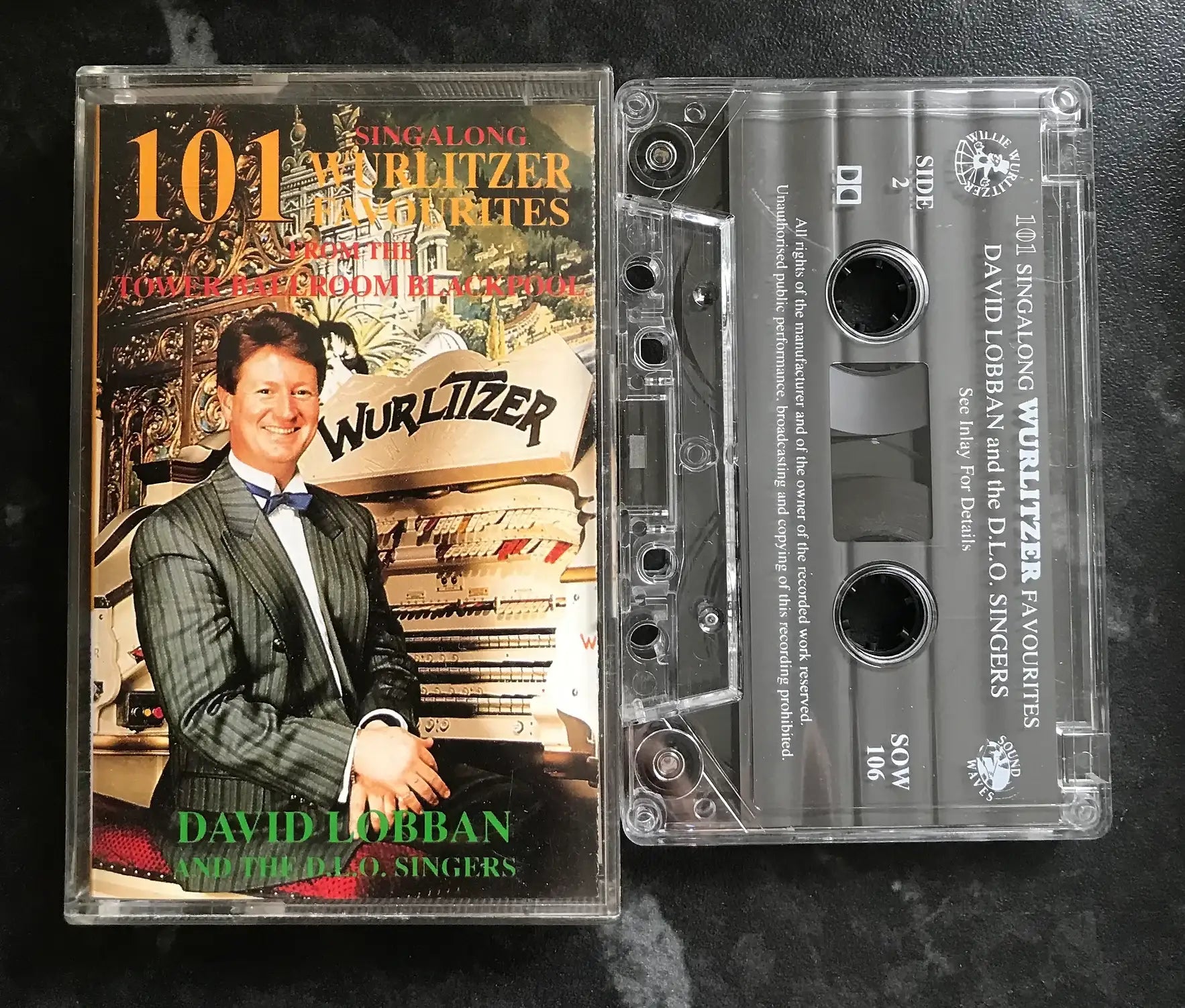 Vintage cassette of "101 Singalong Wurlitzer Favourites" by David Lobban, with clear case and printed label.