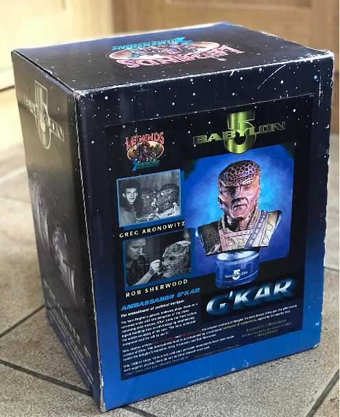 Box for 'Babylon 5' character G'Kar with images and text on a tiled floor.
