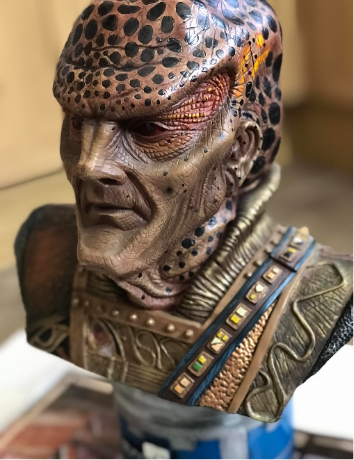 Close-up of a detailed bust with intricate designs and textures.