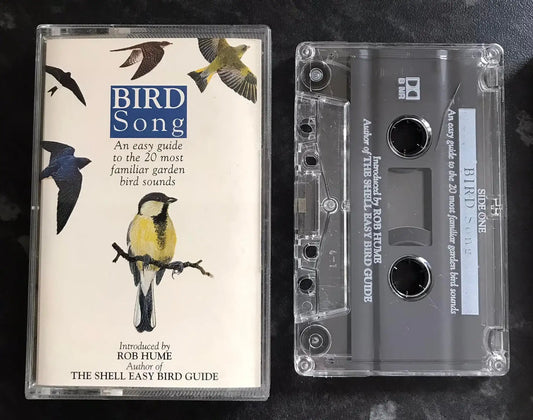 Cassette tape and its cover featuring bird illustrations on a dark background