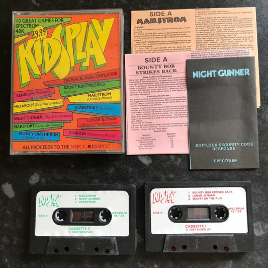 Collection of vintage computer software packages and tapes on a dark surface