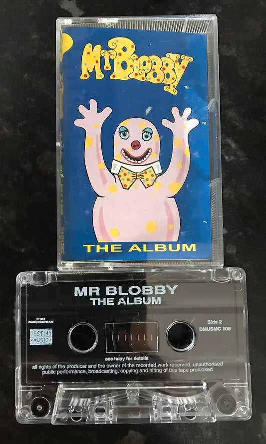 Cassette tape with 'Mr Blobby The Album' on a dark background