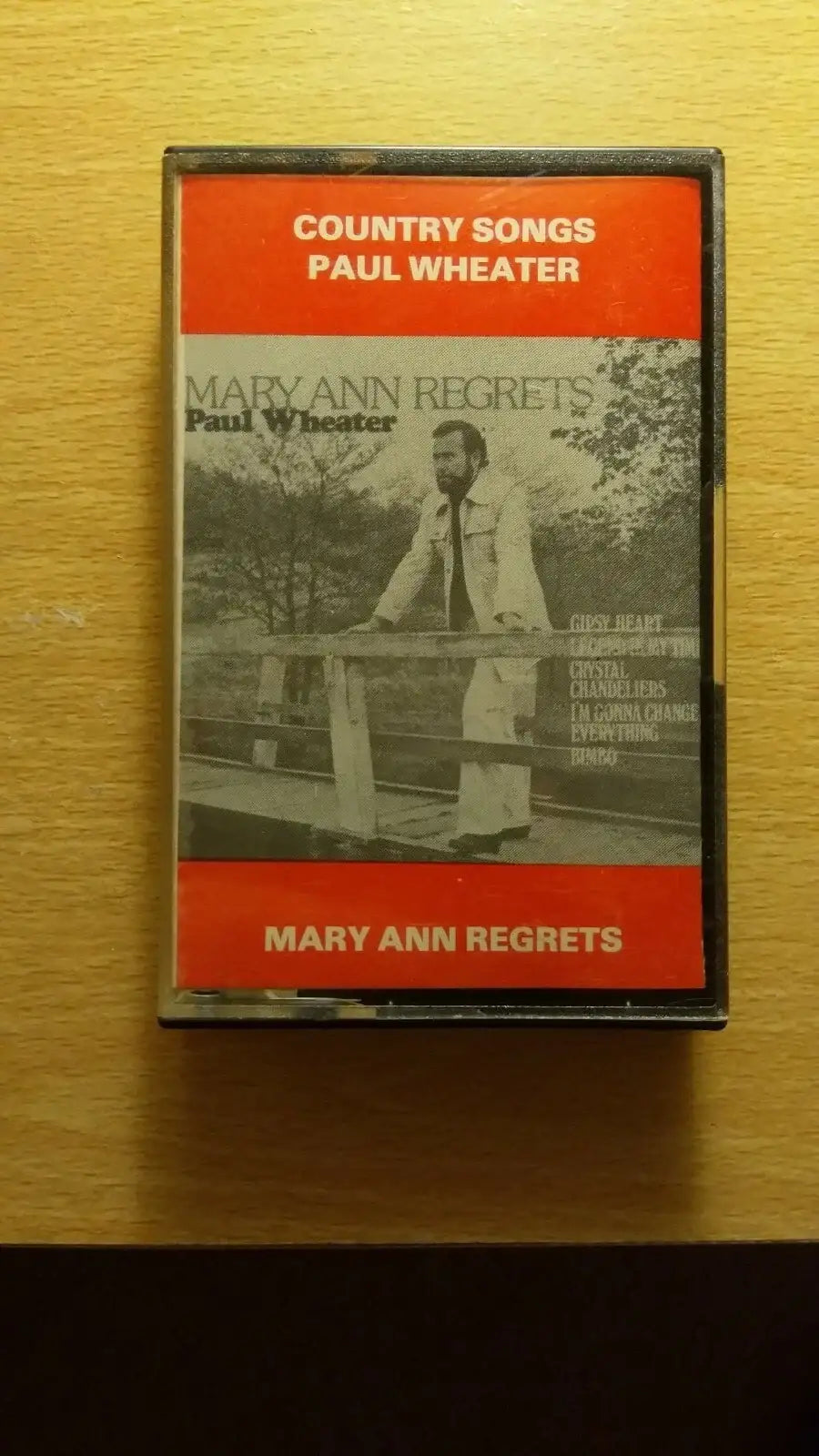 Vintage Paul Wheater "Mary Ann Regrets" cassette tape with red and black cover, featuring a man on a bridge.