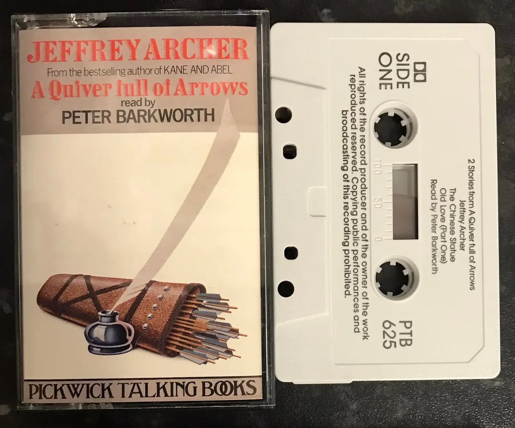 Vintage Jeffrey Archer "A Quiver Full of Arrows" audiobook cassette with white tape and clear case.