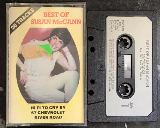 Vintage "Best Of Susan McCann" cassette tape with clear case, black tape, and yellow cover featuring a woman.